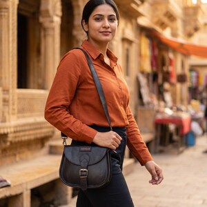 The Marwari Sling in Black worn cross-body through an old Rajasthani bazaar lane (AI-generated)
