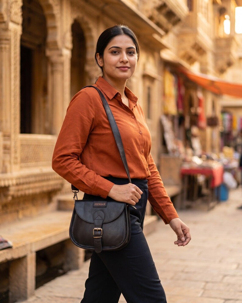 The Marwari Sling in Black worn cross-body through an old Rajasthani bazaar lane (AI-generated)