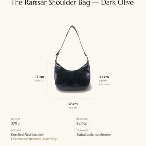Specification card for The Ranisar Shoulder Bag in dark olive: 28 cm wide, 17 cm high, 11 cm deep, 370 g, zip top, full-grain leather, babul bark tannage. Made by Manish.