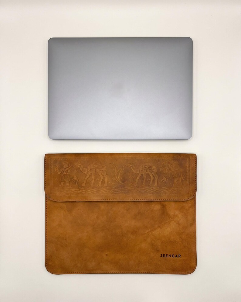 The Barmer Tech Sleeve, 13-inch edition, shown beside the laptop it is cut for (AI-generated)