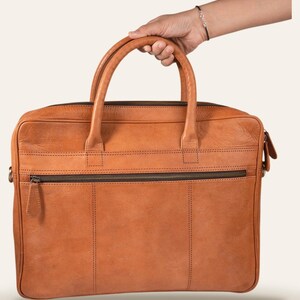 The Sonar Briefcase, carried by its twin rolled leather handles