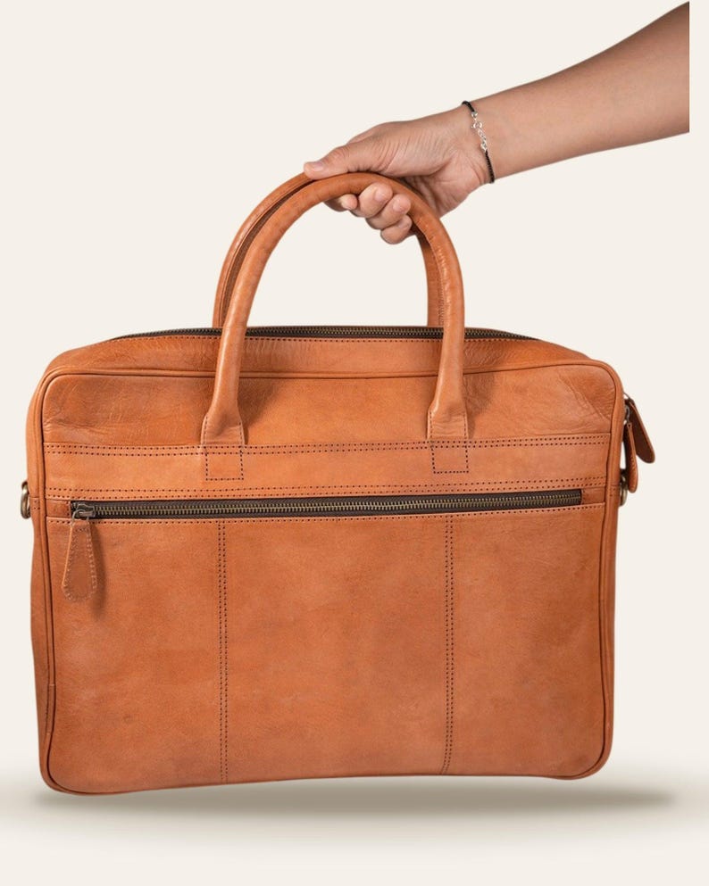 The Sonar Briefcase, carried by its twin rolled leather handles