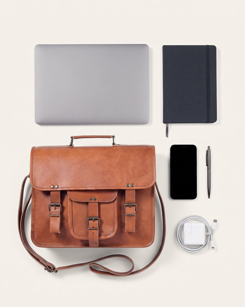 The Mewad Messenger, 13-inch size, shown with a 13-inch laptop, A5 notebook, phone, charger and pen to show what it holds (AI-generated)