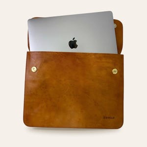 The Barmer Tech Sleeve holding a 13-inch MacBook Air, flap open