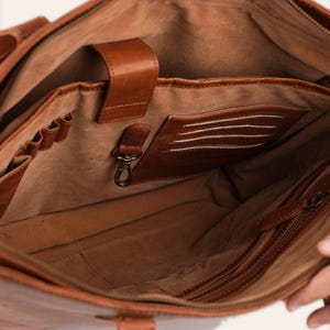 The velvet-lined interior of The Abhaneri Tote with slip pockets, card slots, a pen row and a key leash