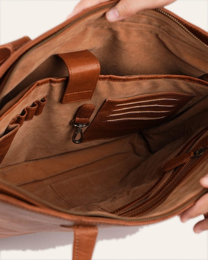 The velvet-lined interior of The Abhaneri Tote with slip pockets, card slots, a pen row and a key leash