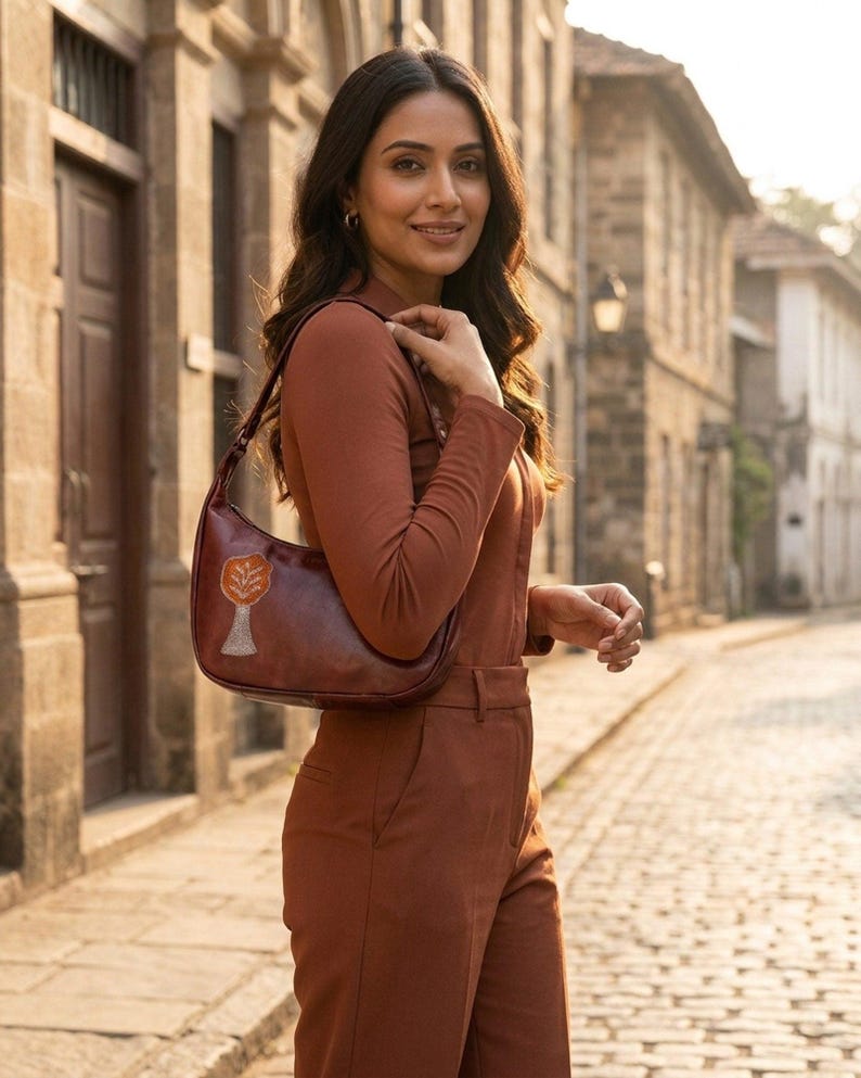 The Kashida Shoulder Bag Padmini in Cherry worn on the shoulder (AI-generated)