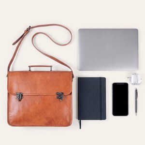 The Jodhpur Messenger, 13-inch size, shown with a 13-inch laptop, A5 notebook, phone, charger and pen to show what it holds (AI-generated)