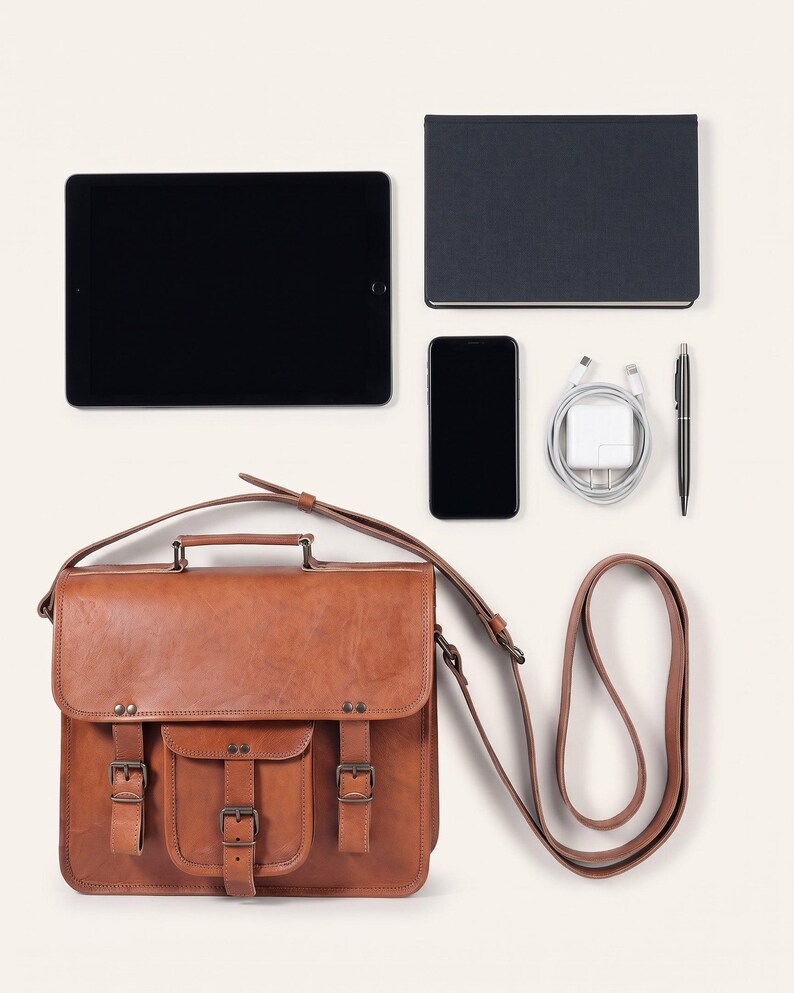 The Mewad Messenger, 11-inch size, shown with an 11-inch tablet, A5 notebook, phone, charger and pen to show what it holds (AI-generated)