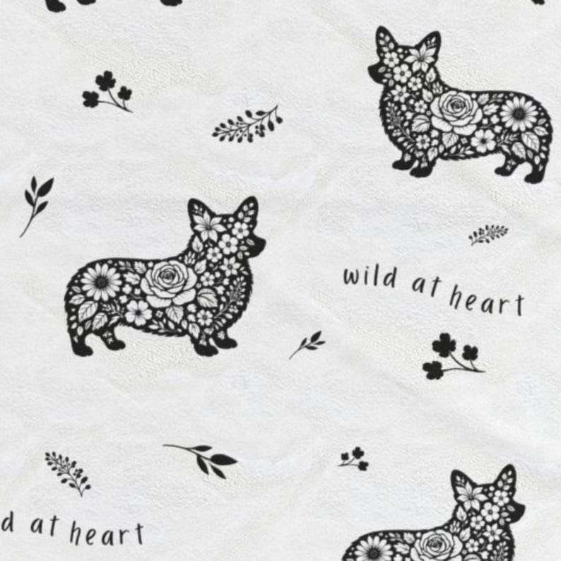 May include: White fabric featuring a repeating pattern of black corgi dog silhouettes filled with floral designs. The phrase "wild at heart" is written in black script, along with small floral and leaf accents.