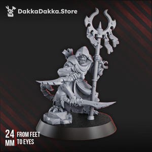 May include: A gray miniature figure of a hooded character holding a staff and two curved blades. The figure is 24 mm from feet to eyes. The DakkaDakka.Store logo is in the top left corner.