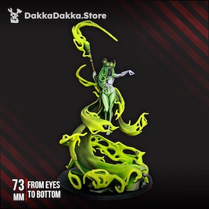 May include: A miniature figurine of a pale figure with long green hair, wearing a dark crown, and holding a staff. The figure is surrounded by swirling, translucent green energy effects. Text on the image reads DakkaDakka.Store and 73 mm from eyes to bottom.
