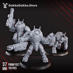 May include: Three grey miniature robot figures with weapon attachments, standing on black circular bases. The text "37 mm from feet to eyes" is visible. The DakkaDakka.Store logo is in the top left corner.