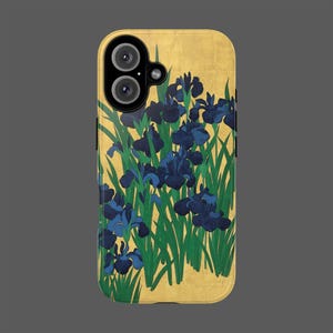 May include: A gold-coloured phone case with a floral design of blue irises and green leaves. The case has a textured appearance and a camera cutout. The design is reminiscent of a Japanese woodblock print.