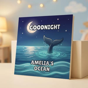 May include: A square book cover featuring a dark blue night sky with a crescent moon and stars. A whale tail emerges from the ocean water below. The text reads GOODNIGHT at the top and AMELIA'S OCEAN at the bottom in white block lettering.