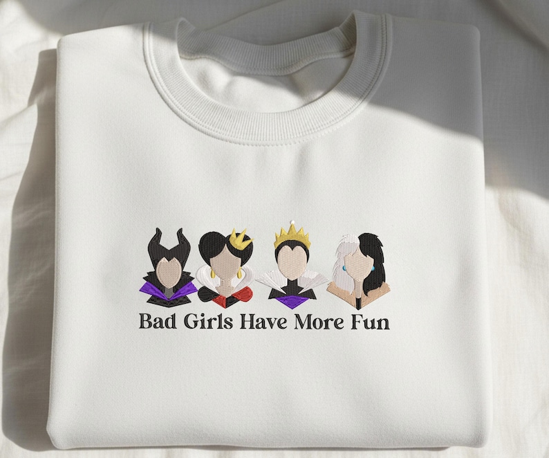 May include: White sweatshirt with embroidered cartoon images of four characters. The characters are in black, purple, red, and gold. The text "Bad Girls Have More Fun" is embroidered below the characters.