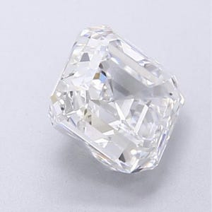 May include: A radiant-cut diamond with a brilliant, multifaceted surface. The colorless gemstone reflects light, showcasing its internal structure and clarity. The diamond's shape is rectangular with cut corners, a classic choice for jewelry.