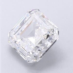 May include: A clear, radiant-cut diamond with a rectangular shape and beveled corners. The facets reflect light, creating a brilliant sparkle. The gemstone is set against a light background, showcasing its clarity and brilliance.