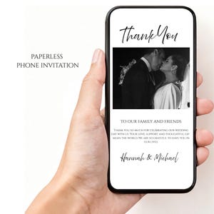 May include: A smartphone displays a digital wedding thank you card. The card features a black and white photo of a couple kissing, with the words "Thank You" at the top. Text includes "To Our Family and Friends" and names.