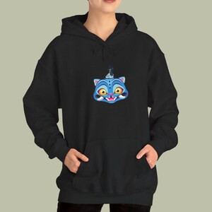 May include: Black hooded sweatshirt featuring a blue cartoon cat face with yellow eyes and a crown. The cat has a wide grin and is centered on the chest. The sweatshirt has a front pocket and a drawstring hood.