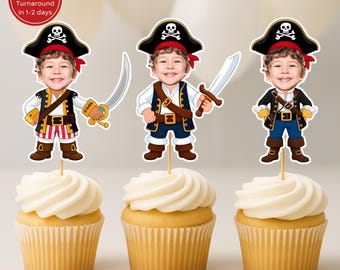 May include: Three cupcake toppers featuring a cartoon pirate with a child's face, each holding a sword. The pirate wears a black hat with a skull and crossbones, a red bandana, and a pirate costume. The cupcakes have white frosting.