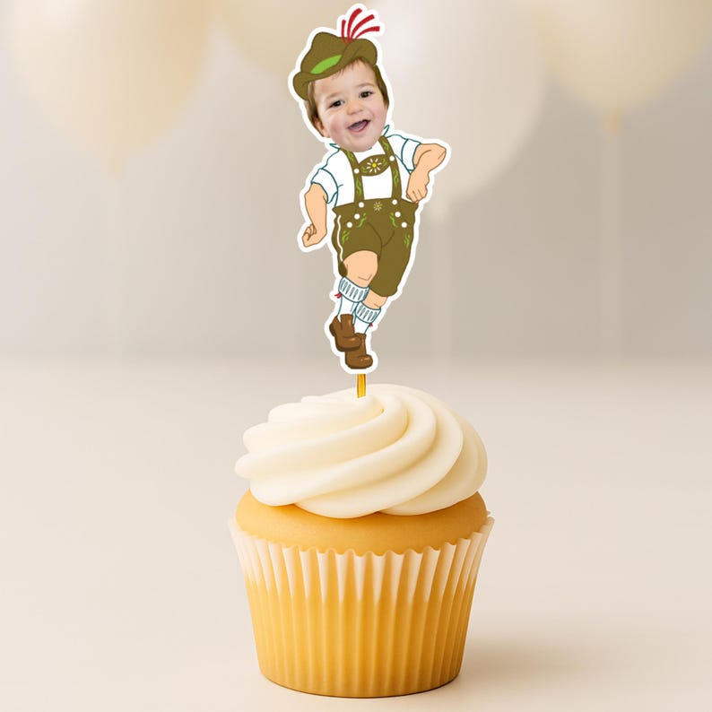 May include: A cupcake topper featuring a cutout of a child's face attached to an illustrated body wearing traditional Bavarian lederhosen, a white shirt, and a green hat with a red feather, all mounted on a thin stick inserted into a cupcake.
