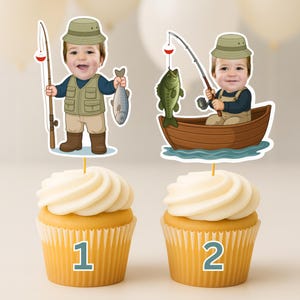 K&ouml;nnte beinhalten: Zwei Cupcakes mit personalisierten Papieraufsteckern. Der erste zeigt einen Cartoon-Angler mit Angelrute und Fisch. Der zweite zeigt einen Cartoon-Angler in einem Holzboot mit Angelrute und einem gr&uuml;nen Fisch. Beide zeigen das Gesicht eines Kindes.