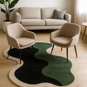 May include: A modern living room setup featuring a beige sofa, two armchairs, and a unique rug. The rug has an abstract design with black, green, and beige sections. The chairs have black legs and beige upholstery. A potted plant adds a touch of nature.