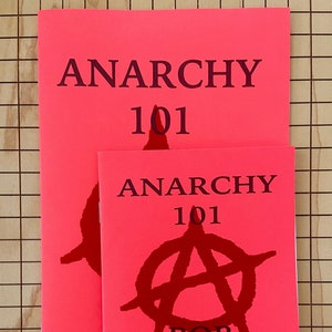 May include: Two pink pamphlets with the title "Anarchy 101" printed in black. The smaller pamphlet has a red anarchy symbol and the text "Bob Black" printed in black.