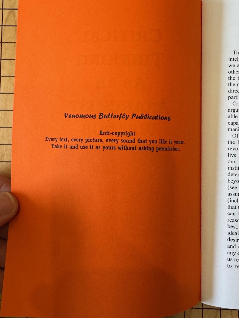 May include: A close-up of a bright orange page with black text. The text reads "Venomous Butterfly Publications" and "Anti-copyright" with a statement about using the content without permission.