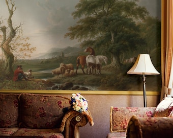 May include: A detailed mural depicting a pastoral scene with horses, sheep, and a figure in a red coat. The artwork is framed by a gold border and is above a floral patterned sofa. A bouquet of flowers rests on the sofa arm.