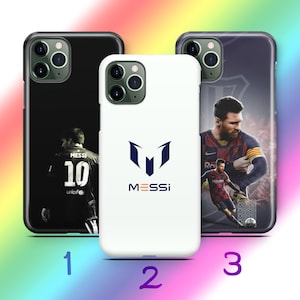 May include: Three phone cases with different designs. A black case features a soccer player with the number 10. A white case displays a blue logo and the name "MESSI". The third case has a photo of a soccer player.