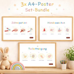 May include: A set of three framed A4 posters with instructions for brushing teeth, washing hands, and using the toilet. The posters have colorful illustrations and text in German. A stuffed bunny and rainbow decor are in the foreground.