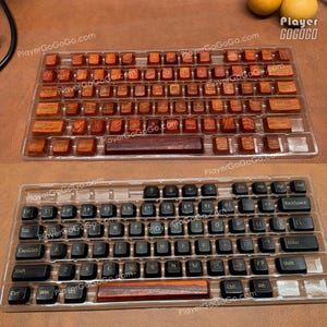 May include: Two mechanical keyboard keycap sets. One set features wooden keycaps in shades of brown and orange. The other set has black keycaps. Both sets are displayed in clear plastic trays. The website PlayerGoGoGo.com is visible.