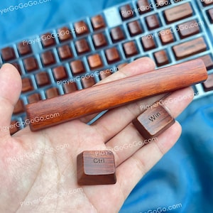 Puede incluir: Primer plano de teclas de teclado y una barra espaciadora de madera. Las teclas son de color marrón intenso con las palabras "Ctrl" y "Win" impresas. La barra espaciadora es rectangular y también de madera. Un teclado está en el fondo.