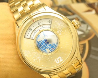 Reloj automático de hombre con indicación de hora saltante / Esfera tipo globo terráqueo chapada en oro, estilo retrógrado