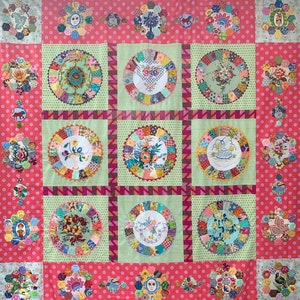 May include: A colorful quilt with a patchwork design featuring various floral and geometric patterns. The quilt is made up of squares and rectangles, each with a different design. The quilt is a vibrant mix of colors, including red, pink, blue, green, yellow, and orange.