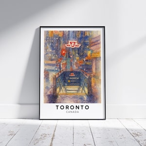 May include: A framed watercolor print of the St. Andrew subway station in Toronto, Canada. The artwork features a detailed depiction of the station entrance, with the TTC logo and the words "St. Andrew" visible. The print is set against a backdrop of city lights.