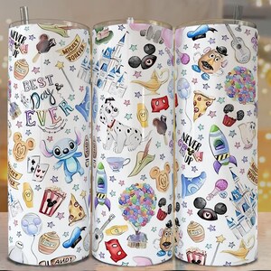May include: Three white insulated tumblers with colorful Disney-themed illustrations. The designs include characters like Stitch, Mickey Mouse, and Dalmatian, along with the text "Best Day Ever" and "Never Grow Up."