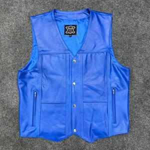 Może przedstawiać: Żywa niebieska skórzana kamizelka z dekoltem w kształcie litery V. Kamizelka ma dwie przednie kieszenie z zamkami błyskawicznymi, zatrzaski i etykietę z tekstem. Klasyczny styl.