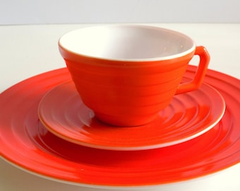 Hazel Atlas Moderntone Place Setting in Radioactive Red, Dinner Plate, Tea Cup, and Saucer. Red-Orange Platonite “Carnivalware” Dinnerware