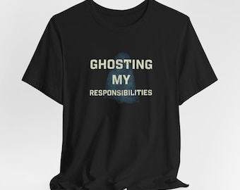 May include: Black t-shirt with the text "GHOSTING MY RESPONSIBILITIES" in a distressed font. A blue and white ghost graphic is centered below the text. The shirt is a short-sleeved crew neck.