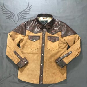 May include: A set of three ceramic mugs with a speckled, matte finish. The mugs are in cream, light grey, and dark grey. Each mug has a simple, minimalist design, ideal for coffee or tea.