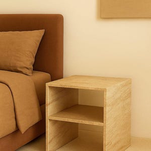 May include: A light-colored wooden nightstand with two shelves. The nightstand is next to a bed with a brown headboard and bedding. The room has a neutral color palette.