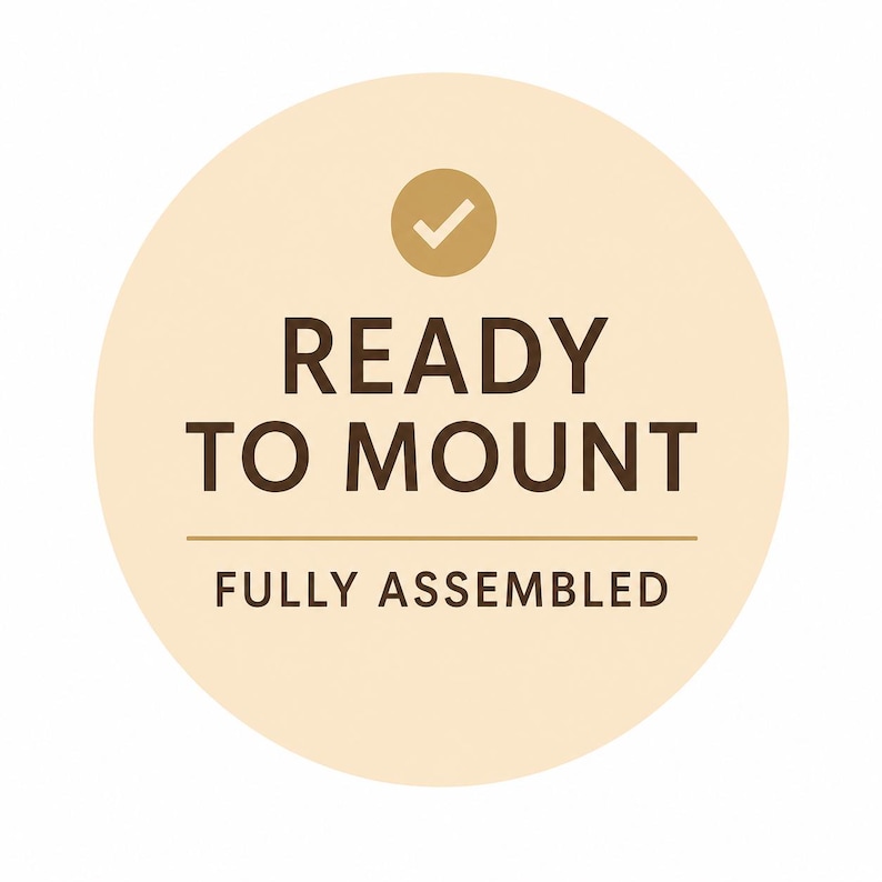 May include: A circular beige sticker with the text "READY TO MOUNT" in dark brown, with a checkmark icon above the text. Below the text is the phrase "FULLY ASSEMBLED".