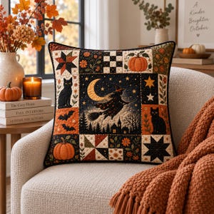 May include: A square decorative pillow featuring a patchwork design with Halloween motifs including a witch flying on a broomstick, black cats, bats, pumpkins, stars, and floral patterns in a color palette of black, orange, and cream.