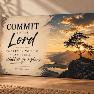 May include: A rectangular canvas wall art piece featuring a sunset landscape with a lone tree on a cliff overlooking a lake. The text reads: COMMIT TO THE Lord WHATEVER YOU DO, AND HE WILL establish your plans. PROVERBS 16:3 in black and gold.