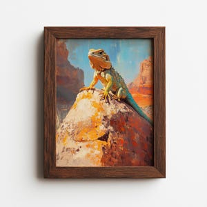 May include: A framed painting of a lizard perched on a rock in a desert landscape. The lizard has a yellow head, green body, and blue tail. The rock is orange and the background features red rock formations and a blue sky.