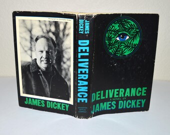 May include: A black and green book cover with the title "Deliverance" by James Dickey. The cover features a stylized eye with a blue iris and a green background.