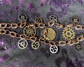 May include: A steampunk-style bracelet with a double chain made of copper and brass. The bracelet is adorned with multiple gears and a watch face.